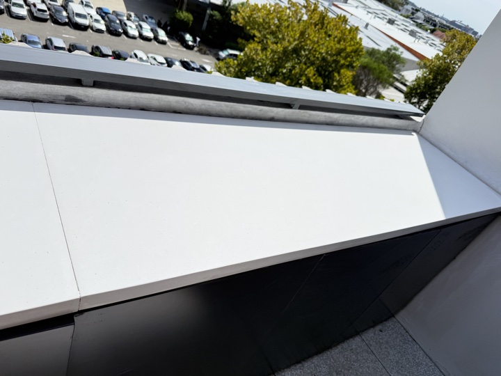 Stained stone capping on a building parapet after the repair