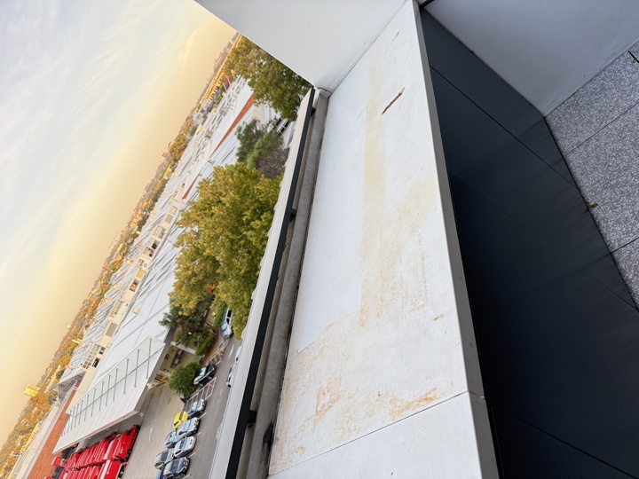 Stained stone capping on a building parapet before the repair