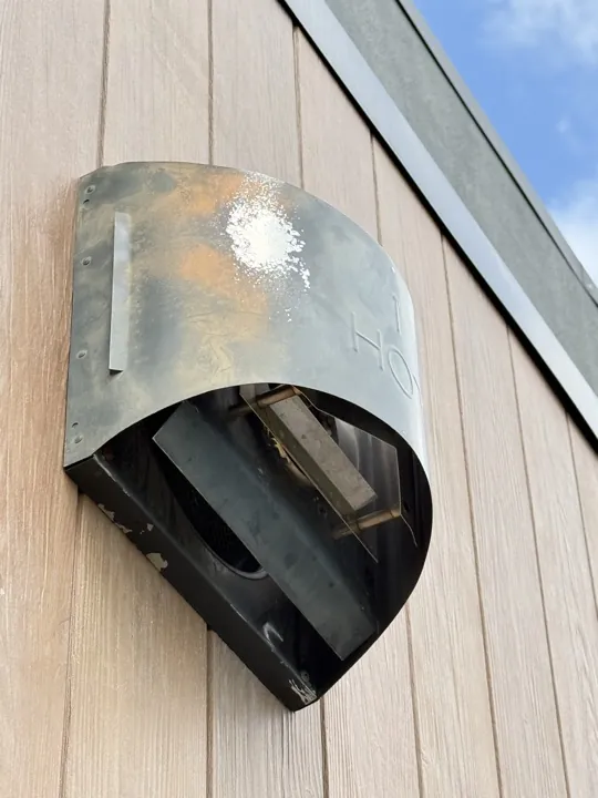 Stained stainless steel cowl before repair