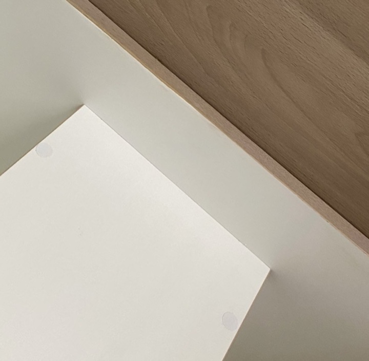 After — chipped white panel edge inside a cupboard beside timber trim