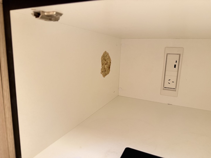 Before — damaged melamine on the inside top panel of a locker