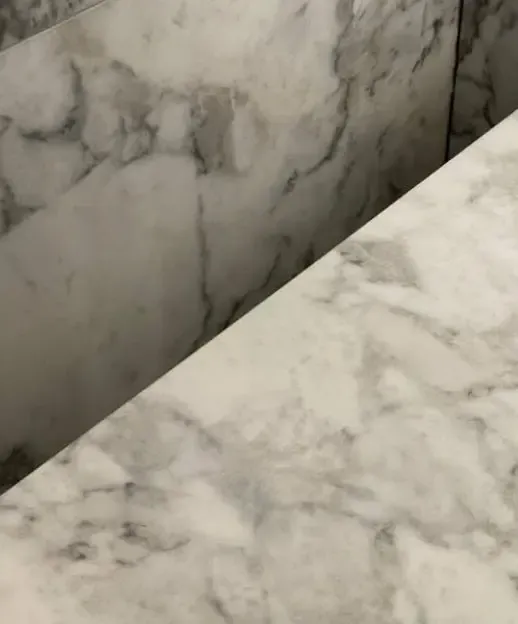 After: core-drilled tap hole in a white marble bench top