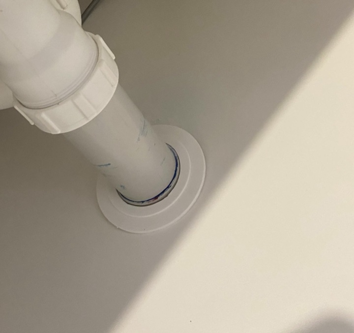 After — oversized hole cut around a waste pipe