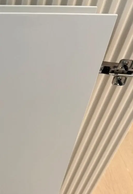 After — chipped edge of a white hinged door