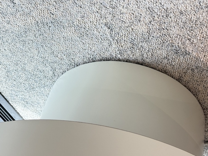 After — chipped bottom edge of a curved seat base on carpet