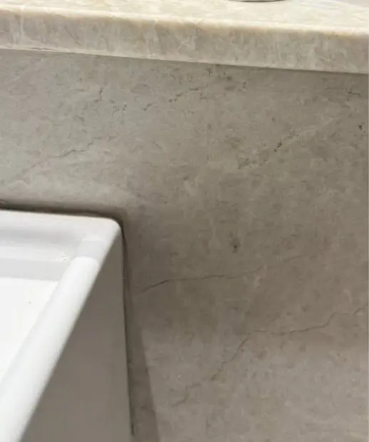 After — chip in the front edge of a stone bench top