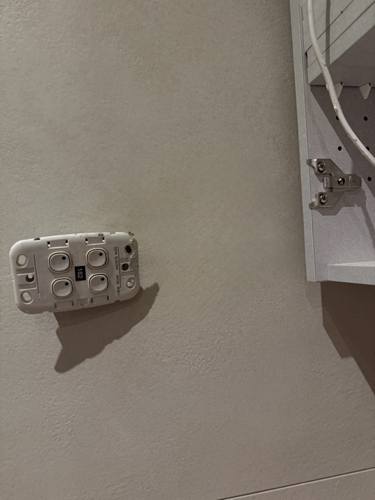 After — rough cut-out in a wall with cabling exposed