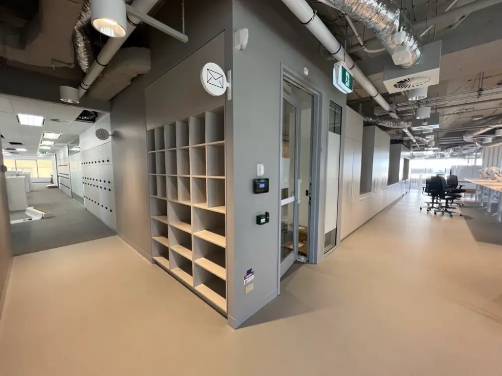 Office joinery and corridor in a commercial fitout nearing handover