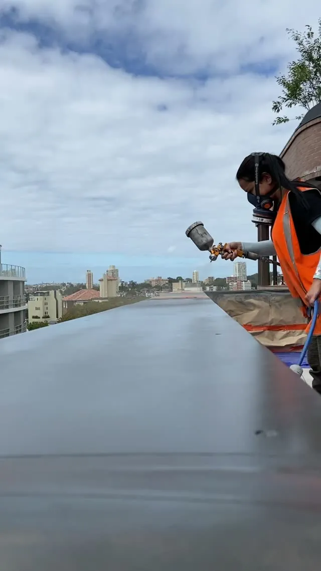 Re-finishing a long metal capping on a rooftop