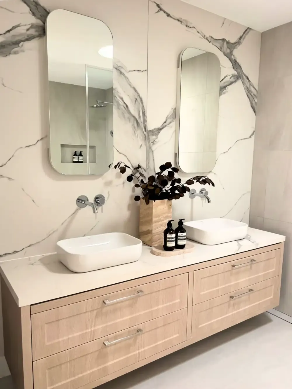 Bathroom with white tiles, an oak vanity and a stone top